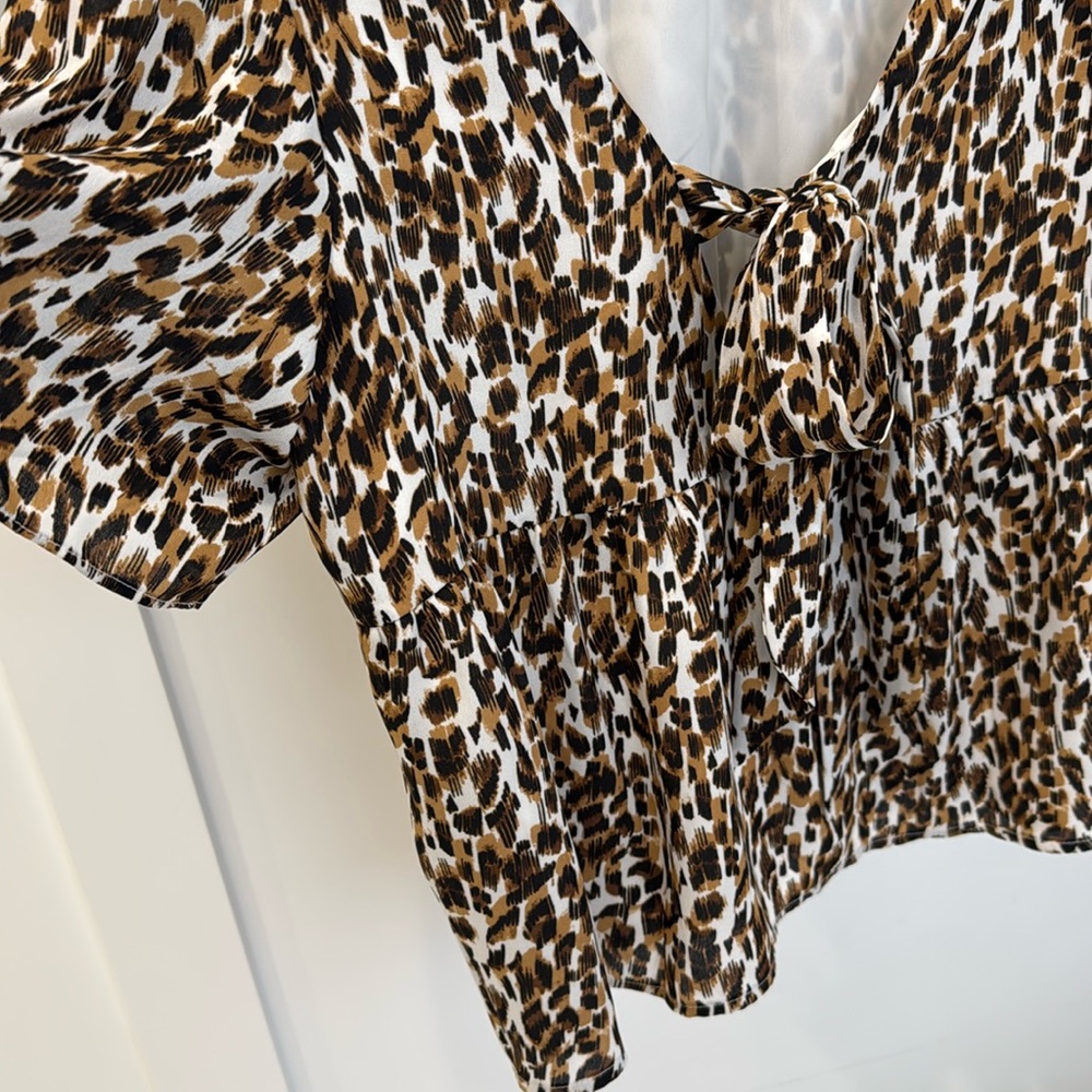 Banana Republic leopard print dressy top with short sleeves and bow at back.
